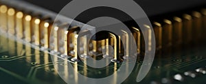 Macro gold microprocessor pin array on green circuit board background