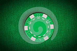 Macro green poker chip on table