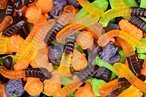 Macro halloween gummy worms witches brooms cats candy photo