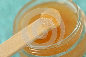 Macro of homemade lip scrub made out of brown sugar, honey and o photo