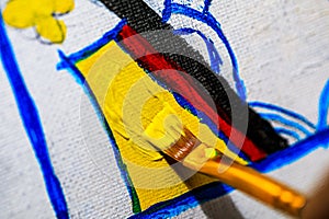 A Macro image of an artist painting a Queen of Hearts playing card on a canvas in their studio.  This very detailed and close up