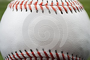 Macro image of a baseball with the closeup on the stitches with copy space