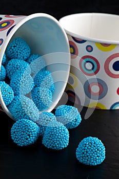 Macro Image of Blue Candies with Colorful Bowls on Black