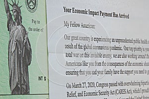 Macro image of cares act stimulus check payment and letter from president Trump due pandemic.