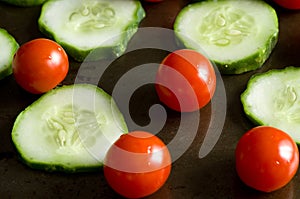 Macro Image of Cherry Tomatoes and Sliced Cucumbers on Cooking Plate