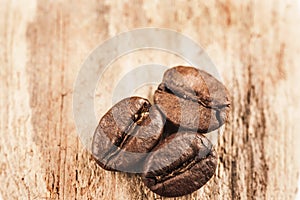 Macro image of coffee beans on wooden surface close up