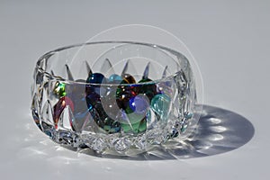 Macro image of colorful dragon tears glass stones in a small crystal bowl