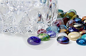 Macro image of colorful dragon tears glass stones surrounding a small crystal bowl