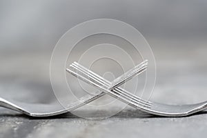 Macro image of cutlery forks on rustic background