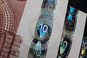 A macro image of the holographic foil features on a Euro banknote, showcasing the security measures in place to prevent