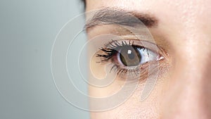 Macro image of human eye with contact lens. Woman`s eye close-up. Human eye with long eyelashes with mascara. Cosmetics