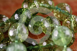 Macro image of natural mineral rock specimen in form of round bead from green jade gemstone