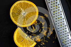 Macro Image of Orange Slices and Grater on Black Background