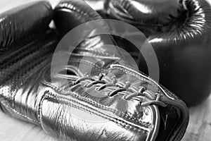 Macro image of a pair of black boxing gloves.