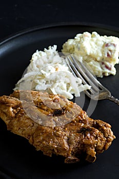 Macro Image of Porc Ribs with Coleslaw and Potatoe Salad