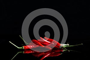 Macro Image of Red Hot Chilly Peppers on Black Background With Reflection