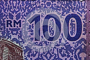 macro image on 100 Ringgit Malaysia (MYR) money with selective focus. photo