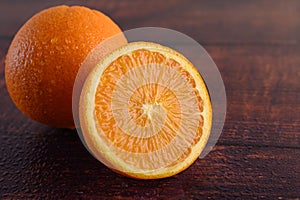 Macro image of ripe orange, on wood background