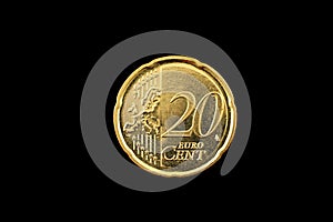 A twenty euro cent coin on black