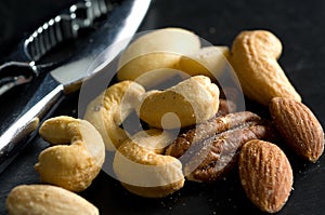 Macro Image of Walnuts, Cashews and Pecans with Chromed Nut Cracker