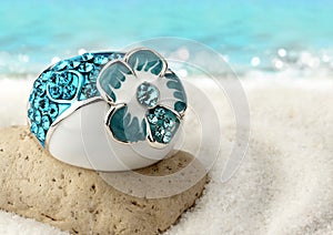 Macro of Jewelery ring on sand beach