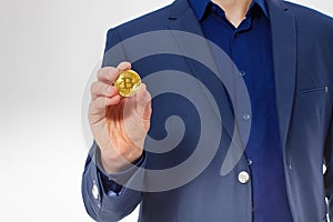 Macro Man in suit holding gold bitcoin coin isolated on white background. Copy space and mock up. Selective focus and business