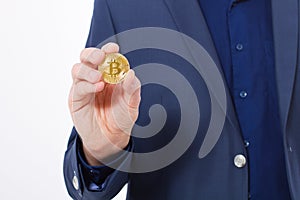 Macro Man in suit holding gold bitcoin coin isolated on white background. Copy space and mock up. Selective focus and business suc