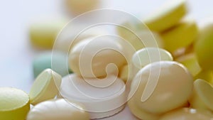 Macro of Medical Pills, Tablets, Capsules and Drugs Falling to White Background