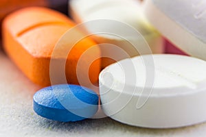 Macro medicine pills, tablets and capsules different colors on white background.Colorful pills background