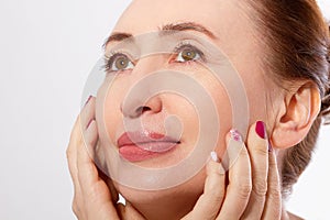 Macro Middle Age Woman Touching her Face and Cleaning Skin . Collagen and face Injections. Anti-aging and Spa concept.