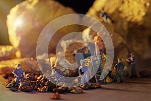 macro miner figures working on group of Bitcoin mining in deep golden cave
