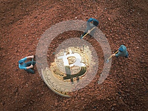 Macro miner figurines digging ground to uncover big shiny bitcoin