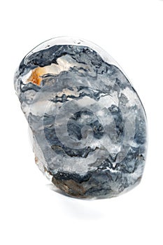 Macro mineral quartz stone with dumortierite on a white background