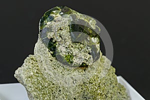 Macro mineral stone Andradite on a black background
