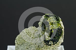 Macro mineral stone Andradite on a black background