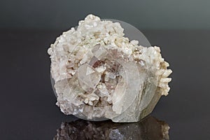 Macro mineral stone Apophyllite stilbite on a gray background