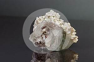 Macro mineral stone Apophyllite stilbite on a gray background