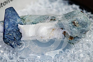 Macro mineral stone Benitoite on a black background