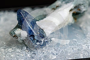 Macro mineral stone Benitoite on a black background