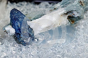 Macro mineral stone Benitoite on a black background