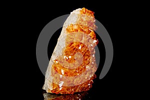 Macro mineral stone Citrine in rock in crystals on a black background