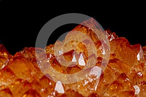 Macro mineral stone Citrine in rock in crystals on a black background