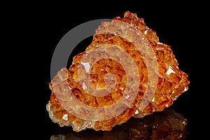 Macro mineral stone Citrine in rock in crystals on a black background