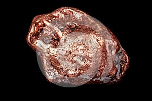 Macro mineral stone of a copper nugget on a microcline on a black background