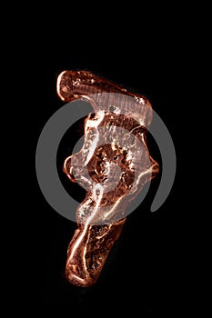 Macro mineral stone of a copper nugget on a microcline on a black background