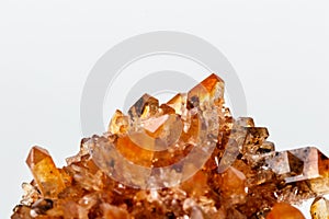 Macro of mineral stone Creedite on microcline on white background