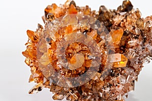 Macro of mineral stone Creedite on microcline on white background