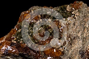 Macro mineral stone Grossular, Garnet, Epidote on a black background