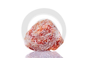 Macro mineral stone orange calcite on a white background