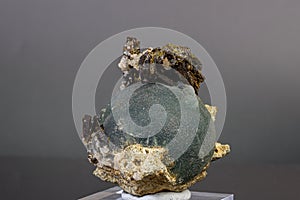 Macro mineral stone Prehnite on Epidote on a gray background